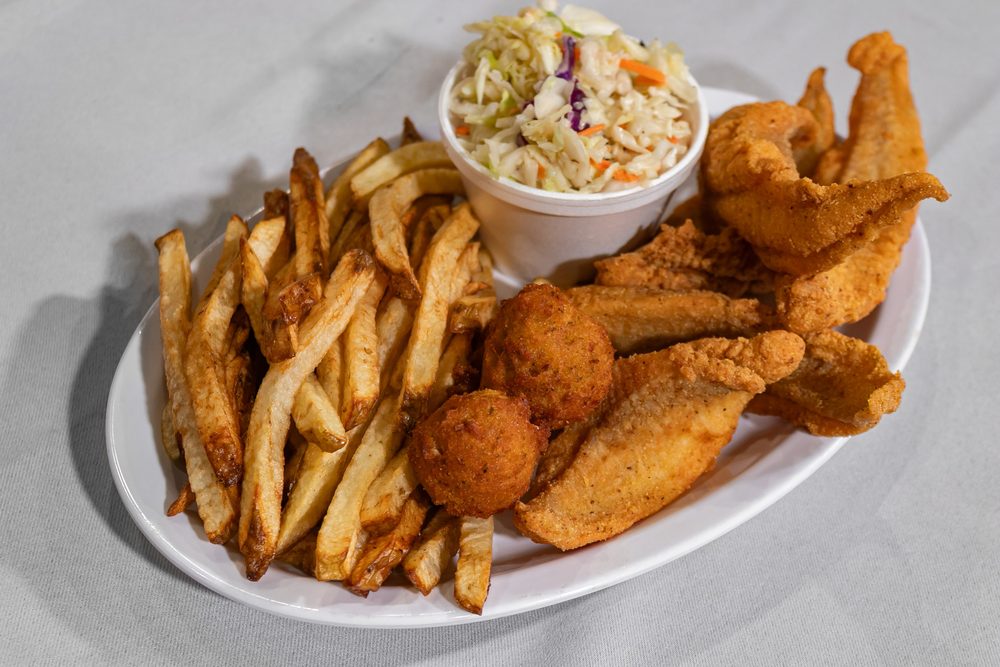 Fried catfish filets with fries and hushpuppies